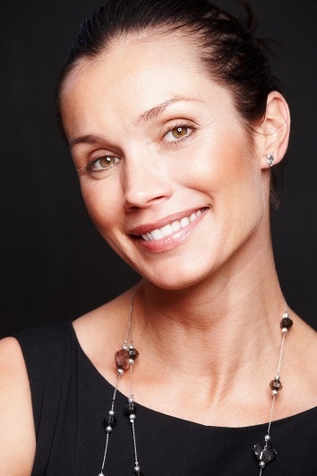 Smiling middle aged woman against black background