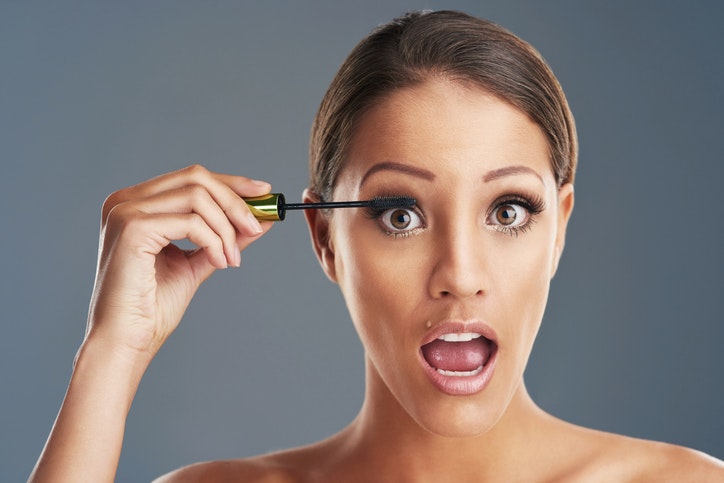 Woman applying mascara